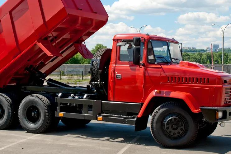 constructin vehicle red dump truck that needs repair and maint
