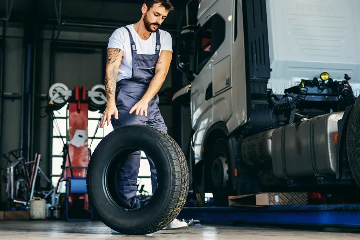 mechanic changing semi truck tire